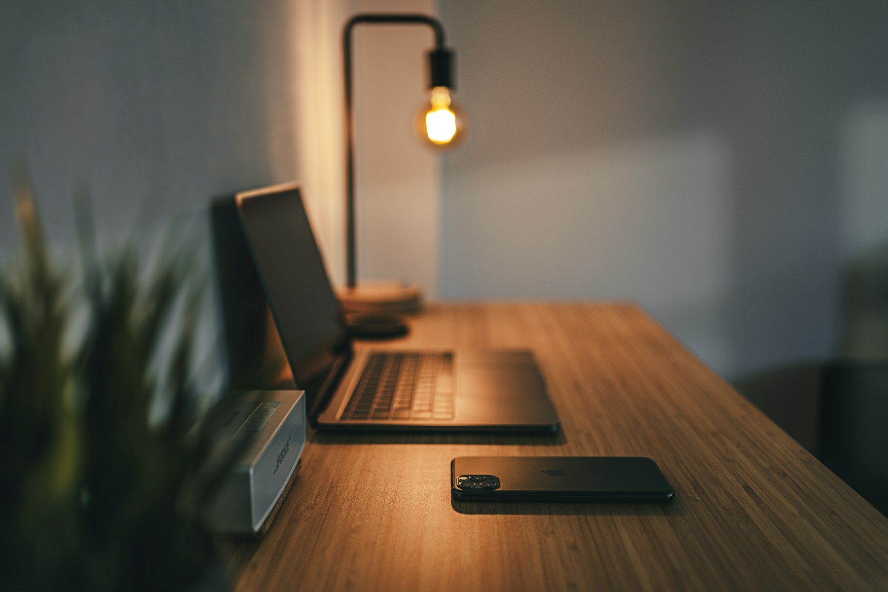 A desk with a lamp in a quiet, dim room
