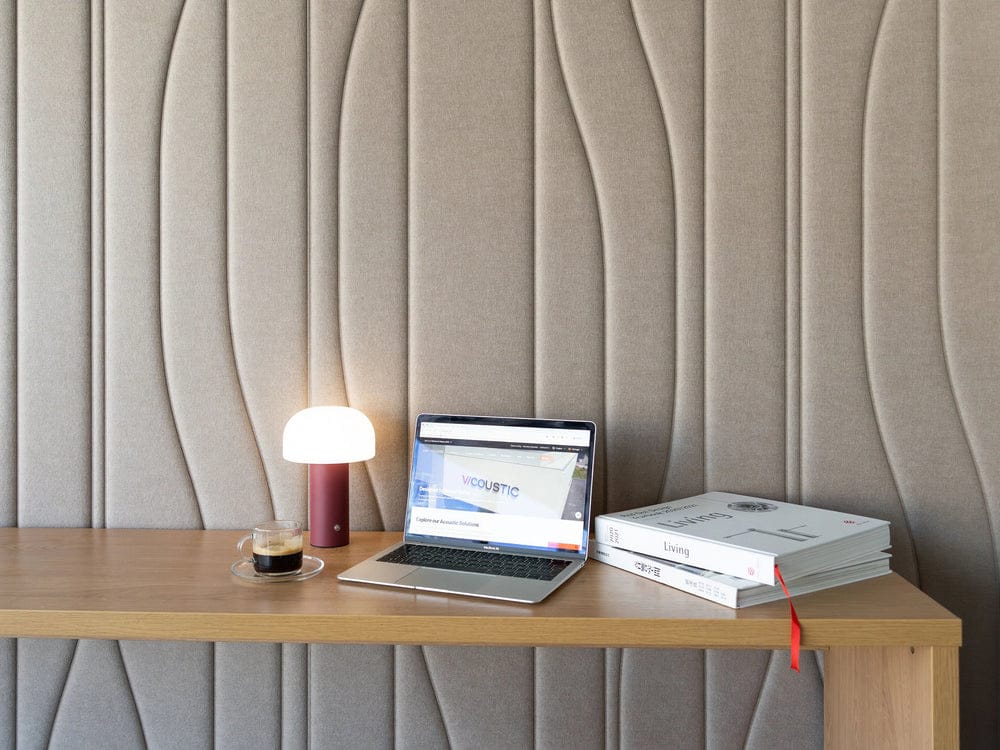 Vicoustic Embossed VMT Aqualine wall panels in pearl behind a wooden desk