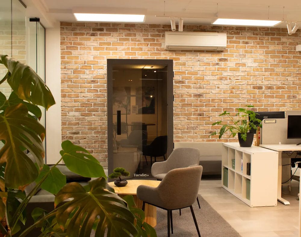Bureau Tuesday pod in a bright office with brick walls