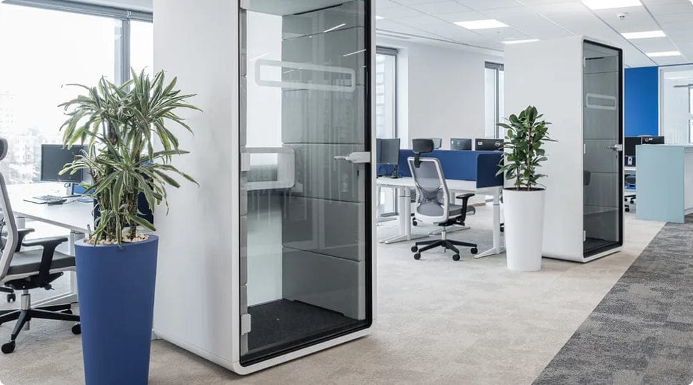 hushPhone office phone booth with a glass door, in an open office