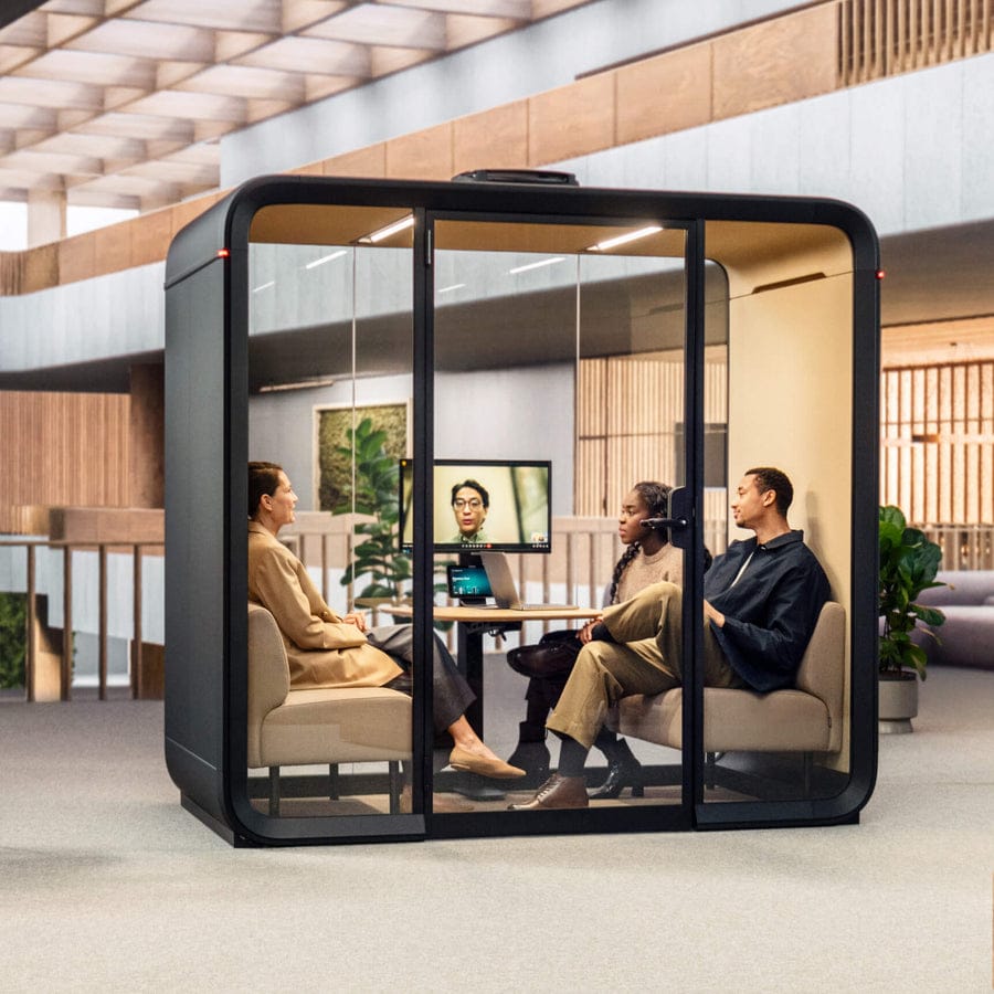 Three people having a meeting inside a Framery Four pod