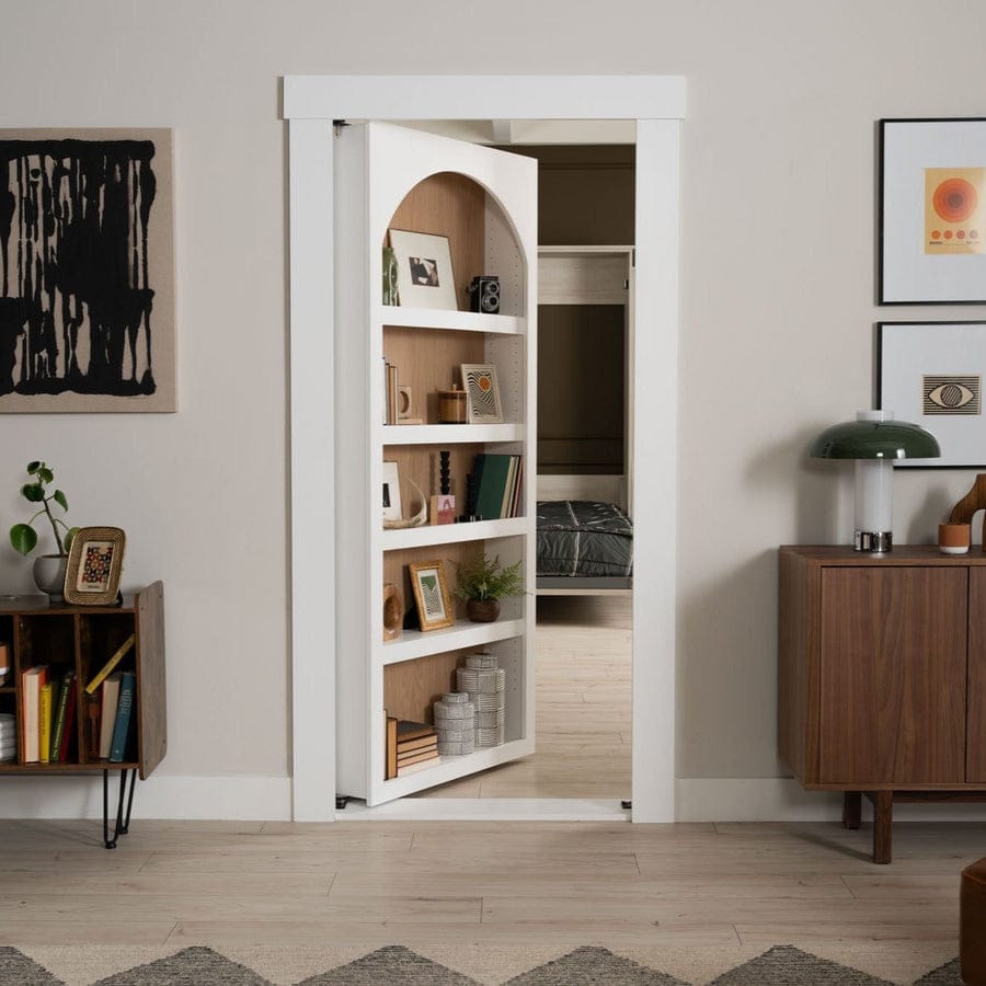 Murphy Door white archway bookcase door, partly open to reveal a bedroom