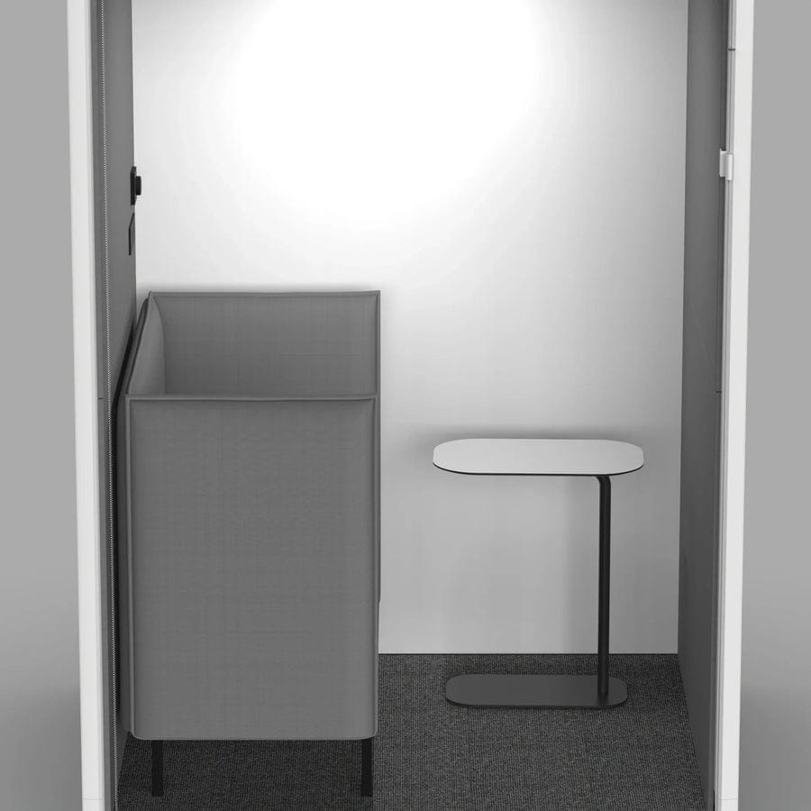 Inside the PrivacyPod Solo Lactation Pod, with a seat and side table